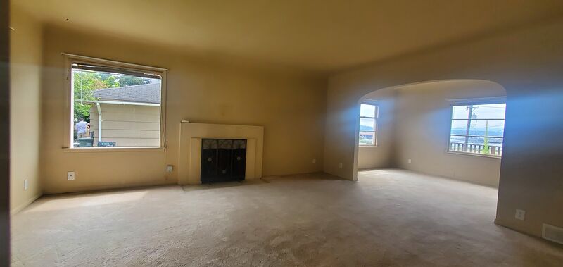 Wide view of the living room with archways and natural light