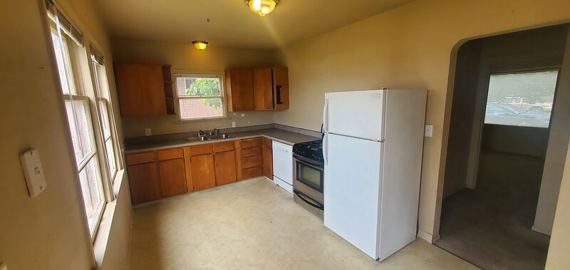 Kitchen with gas stove, refrigerator, and ample cabinet space