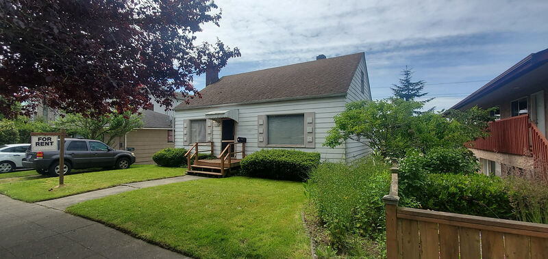 Front of the home with lawn and rental signage